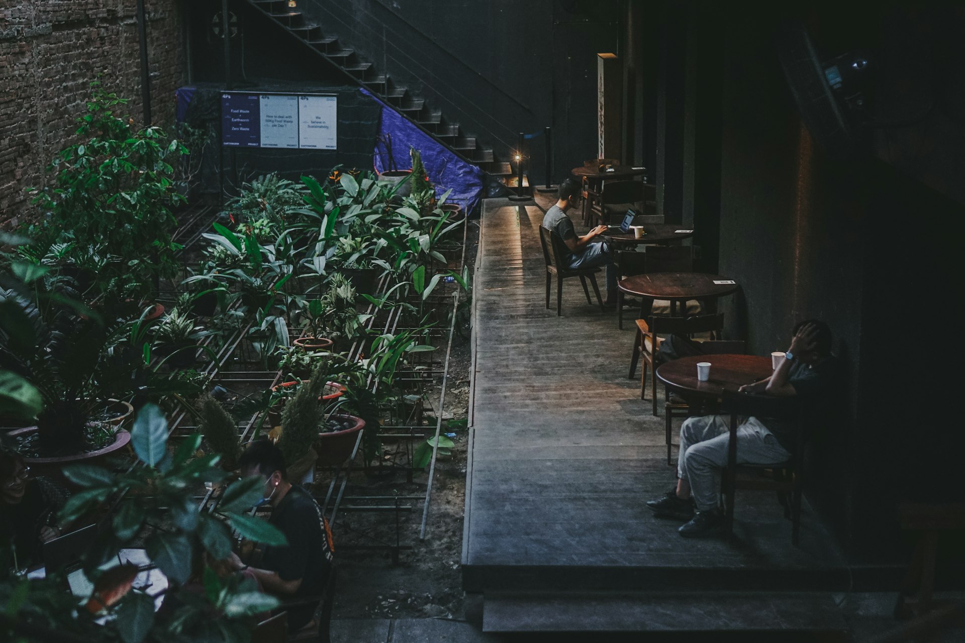 people sitting at tables in a restaurant